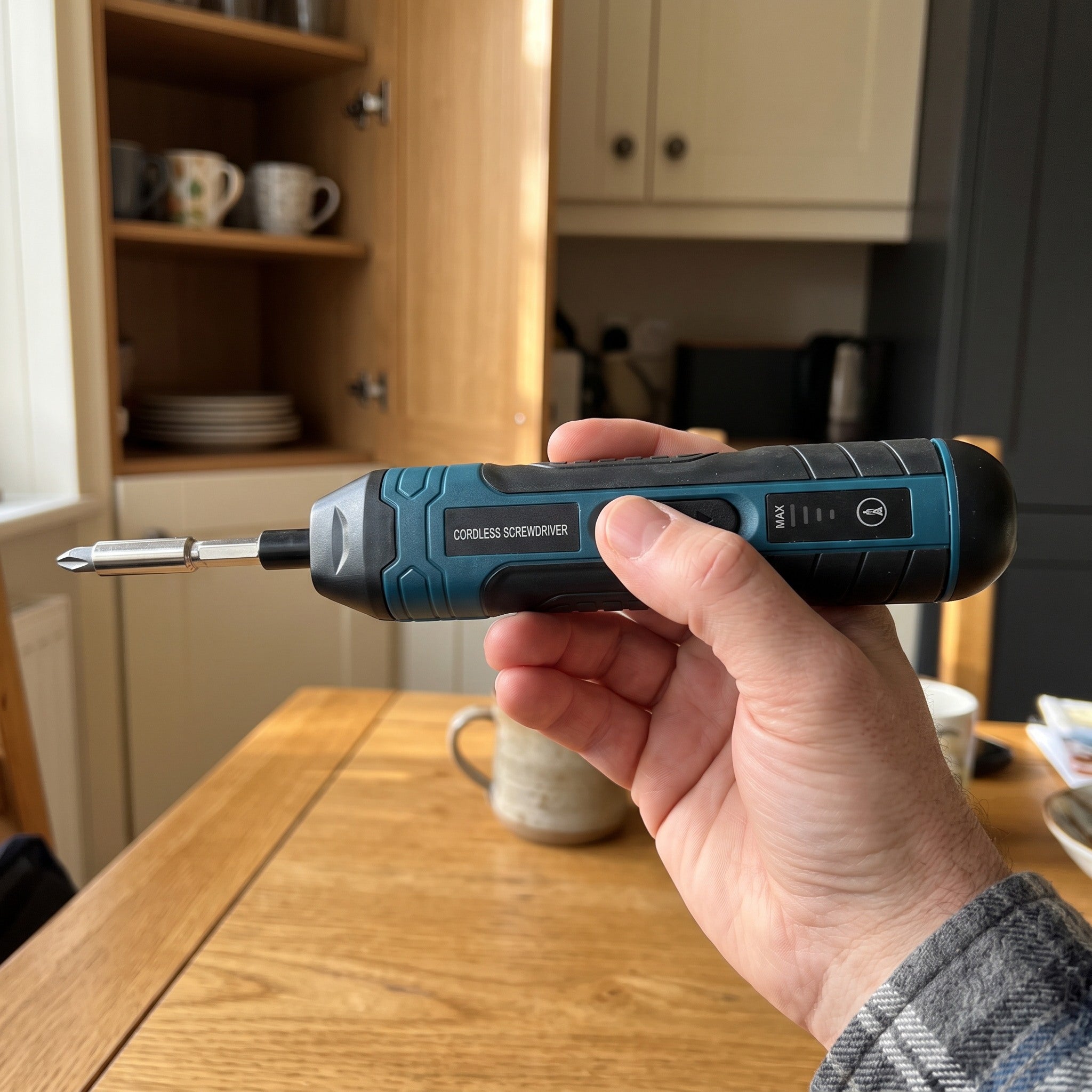 Hand holding Turnwell horizontally beside a cabinet